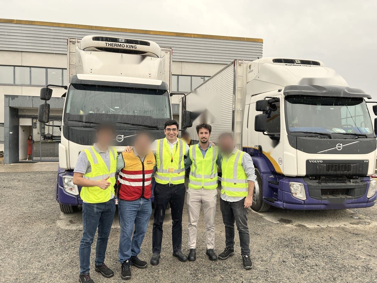 David Herrera with a transport team in front of two refrigerated trucks
